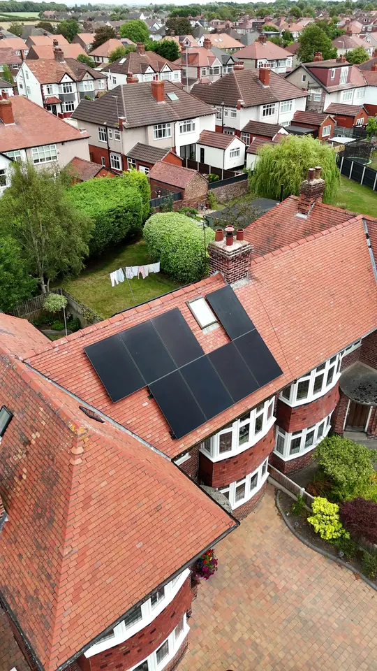 Oblique aerial view of an Edwardian semi-detached house with solar panels on its rear roof slope