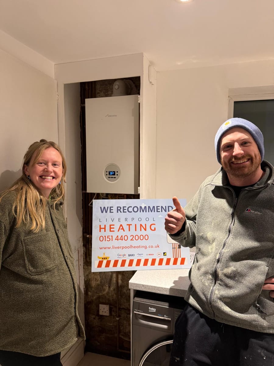 A customer giving a thumbs up beside a newly fitted Worcester Bosch boiler