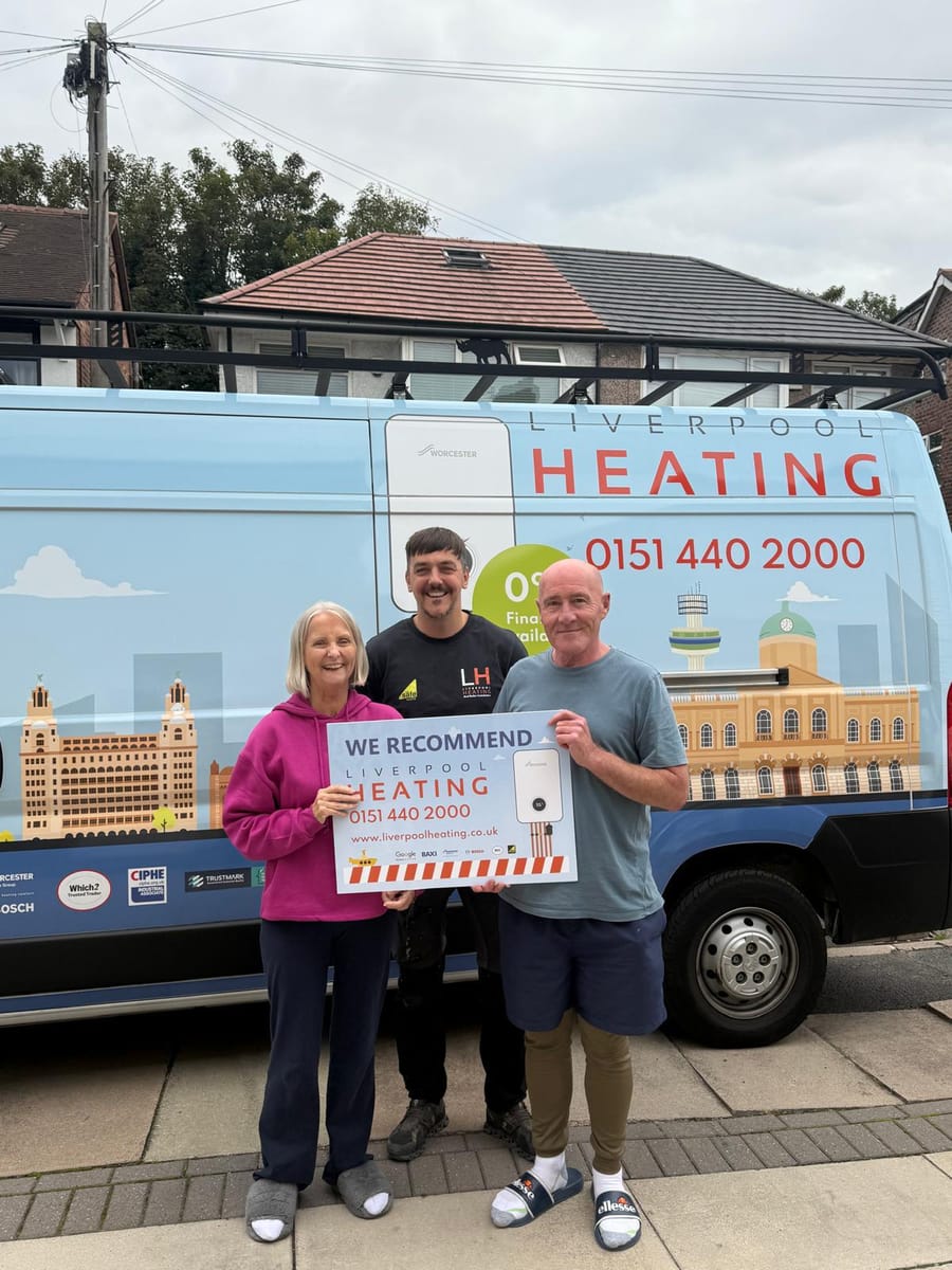 Liverpool Heating engineer with happy customers by the branded van