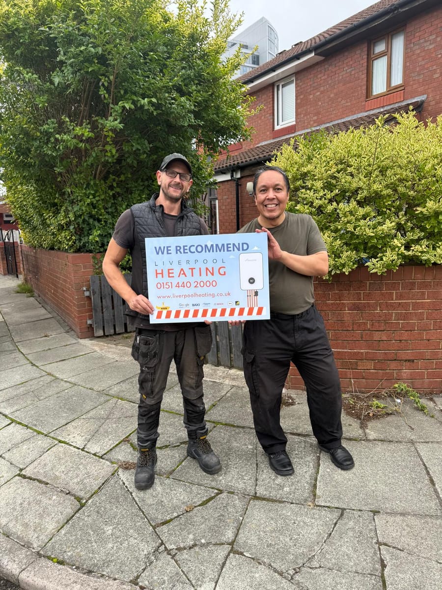 A Liverpool Heating engineer and customer outside a Merseyside home