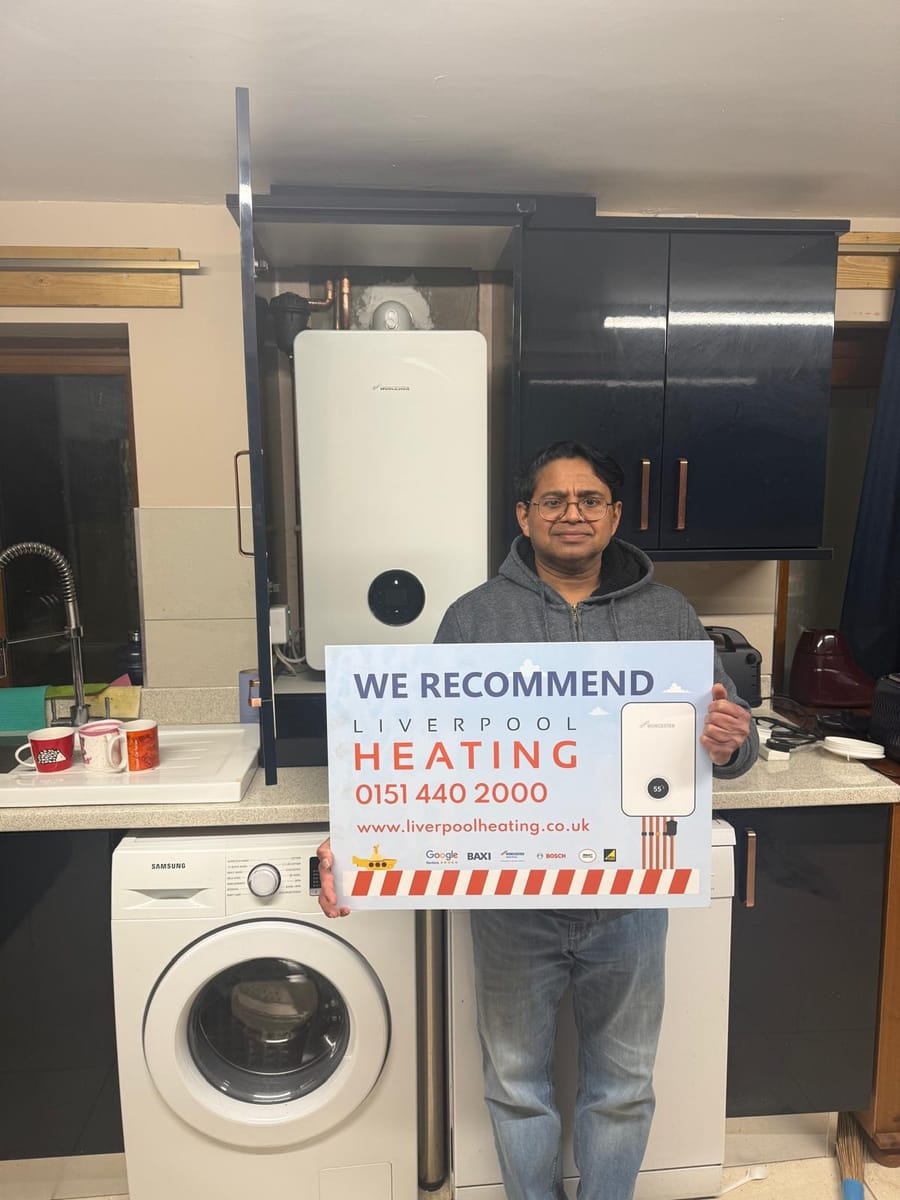 A customer with a We Recommend sign beside a new Worcester Bosch boiler in the kitchen